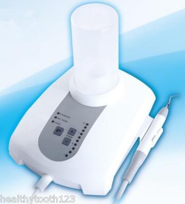 Dental piezoelectric ultrasonic scaler liquid dosing a